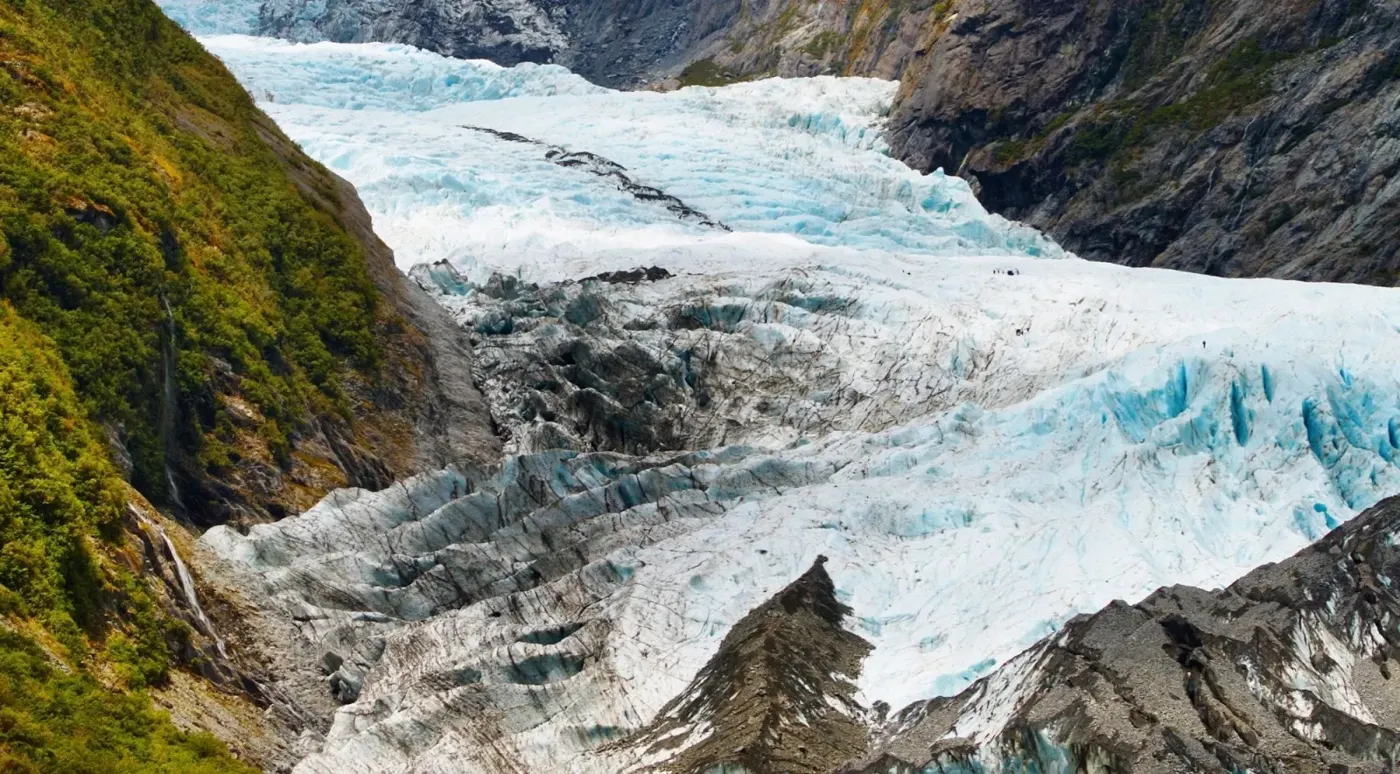 Aerial view of a glacier flowing between valley walls