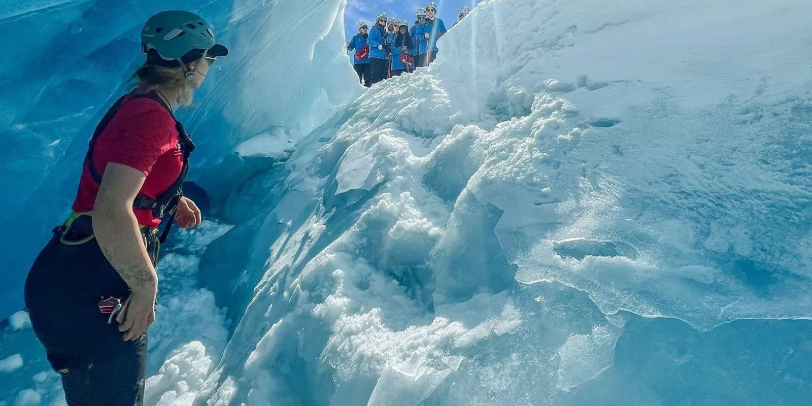 Guide beside a carved glacier ice step