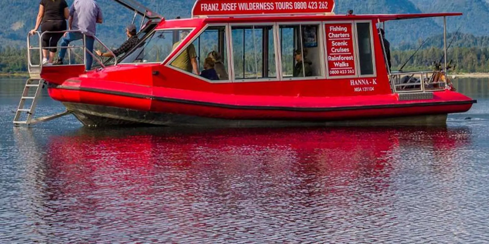 Covered red boat on the lake